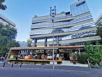 a building with a restaurant in front of it at Victory apartment - Heart of Belgrade in Belgrade