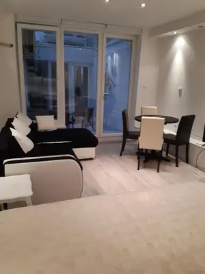 a living room with a bed and a table and chairs at Viktoria in Belgrade