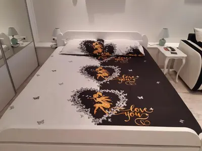 a bedroom with a bed with a black and gold bedspread at Viktoria in Belgrade