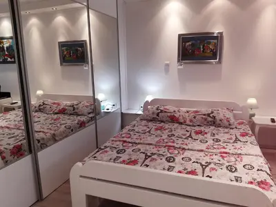 a bedroom with a bed and a mirror at Viktoria brdo in Žarkovo