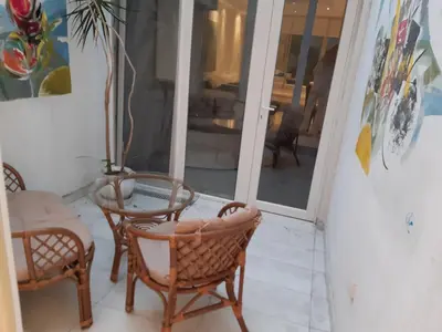 a room with two chairs and a table and a glass door at Viktoria brdo in Žarkovo