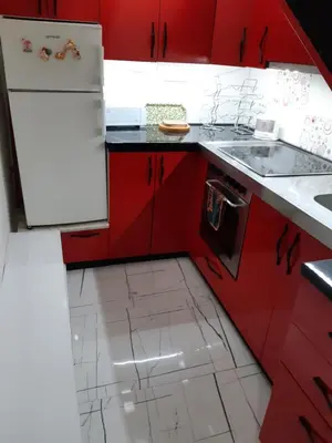 a red kitchen with red cabinets and a sink at Viktoria brdo in Žarkovo