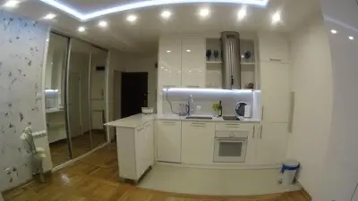 a white kitchen with a sink and a mirror at Babilon in Vračar (historical)