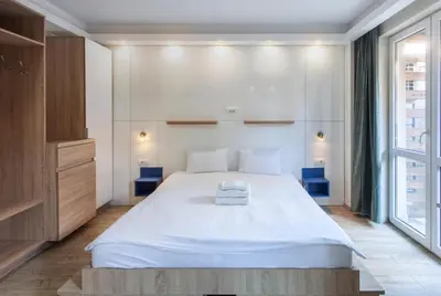 a bedroom with a large white bed and a window at Villa ARS in Belgrade