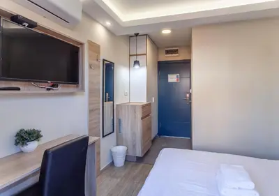 a room with a bed and a flat screen tv at Villa ARS in Belgrade