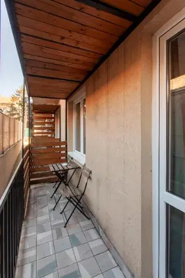 a porch with chairs on the side of a house at Villa ARS in Belgrade