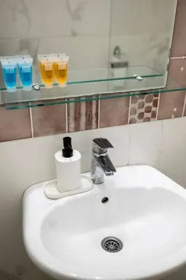 a bathroom sink with two glasses on a mirror at Villa ARS in Belgrade