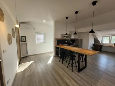 a large kitchen with a wooden counter in a room at Villa ARS in Belgrade