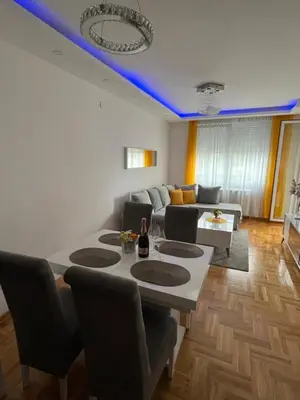 a living room with a table and a couch at Paunov Breg in Jajinci
