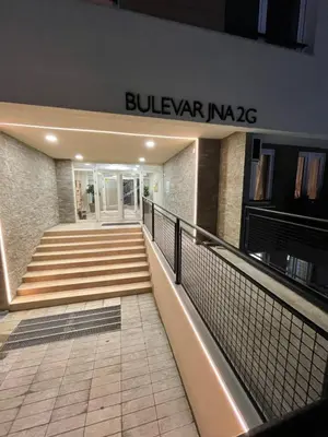 a building with stairs and a sign that reads bulvar naza at Paunov Breg in Jajinci