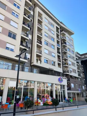 a large apartment building with a lot of windows at Paunov Breg in Jajinci