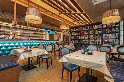 a restaurant with tables and chairs and a bar at Hotel Ub Aqua Park in Ub