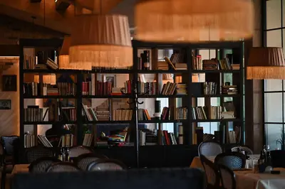 a library filled with lots of books on shelves at Hotel Ub Aqua Park in Ub
