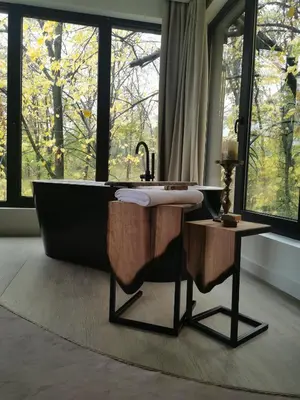 a bathroom with a bath tub and a large window at Hotel Ub Aqua Park in Ub