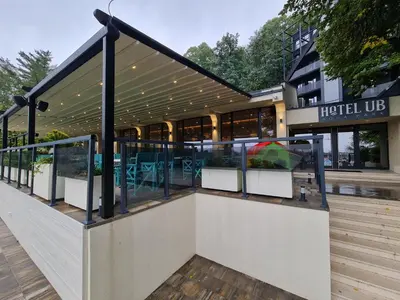 a hotel lobby with tables and chairs in a building at Hotel Ub Aqua Park in Ub