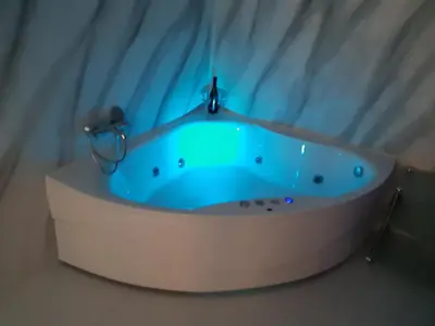 a blue bath tub with a faucet in a bathroom at Djakuzi Viktorija in Belgrade