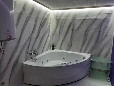 a white tub in a bathroom with a shower curtain at Djakuzi Viktorija in Belgrade