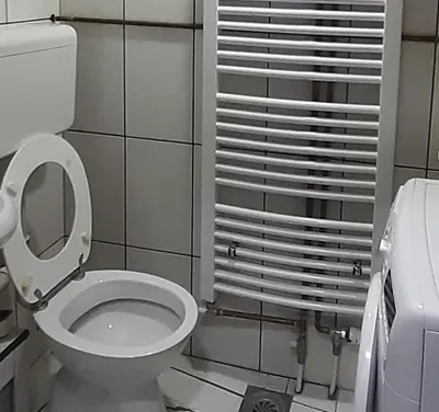 a bathroom with a toilet with the lid up at Djakuzi Viktorija in Belgrade