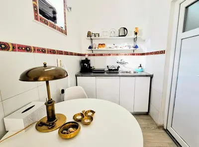 a room with a table with a lamp on it at Angelina apartmani. in Vračar (historical)