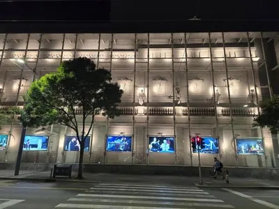 a building with a bunch of screens on the side of it at Angelina apartmani. in Vračar (historical)