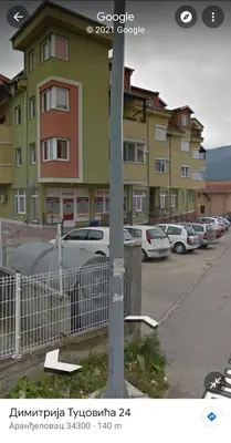 a pole in front of a parking lot with cars at Top Secret in Arandjelovac