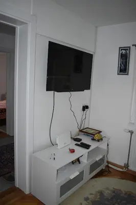 a living room with a tv on a white wall at Baberius in Babe