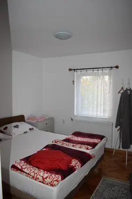 a bedroom with a bed with a red blanket on it at Baberius in Babe