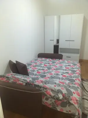 a bedroom with a bed with a flowered blanket on it at MoonZe Gate in Belgrade