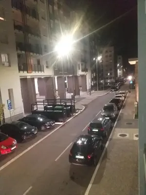 a row of cars parked in a parking lot at night at MoonZe Gate in Belgrade