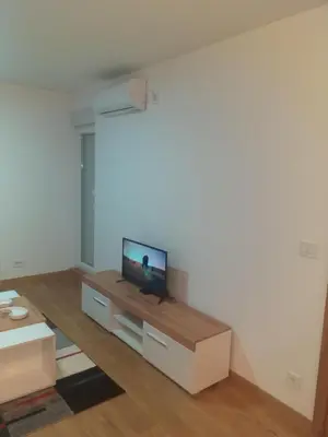 a living room with a flat screen tv on a table at MoonZe Gate in Belgrade