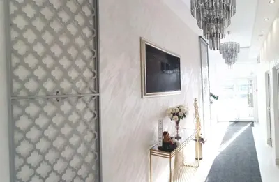 a hallway with a wall with a picture on it at ForS Konak Apartments in Belgrade