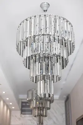 a large silver chandelier hanging from a ceiling at ForS Konak Apartments in Belgrade