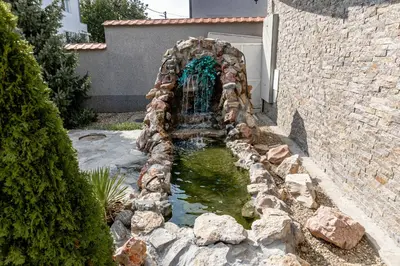 a water fountain in the middle of a yard at ForS Konak Apartments in Belgrade