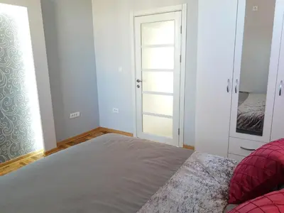 a bedroom with a bed and a mirror at Kalemegra in Belgrade