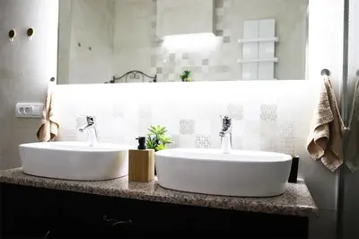 two white sinks on a counter in a bathroom at Kalemegra in Belgrade