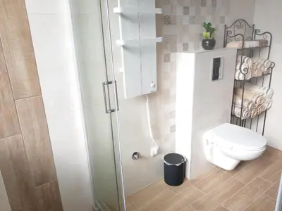 a bathroom with a toilet and a glass shower at Kalemegra in Belgrade