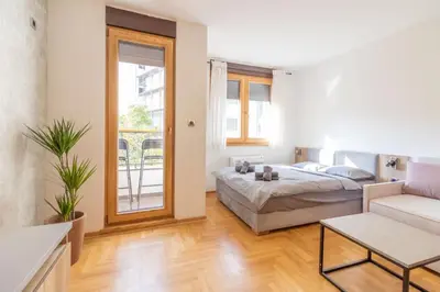 a living room with a bed and a couch at Apartment Bohemia in Belgrade