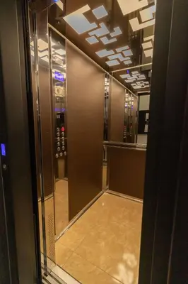a hallway in a building with a room with a mirror at Apartment Bohemia in Belgrade