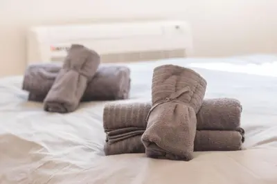 a pair of socks sitting on top of a bed at Apartment Bohemia in Belgrade