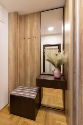 a dressing room with a bench and a mirror at Apartment Bohemia in Belgrade