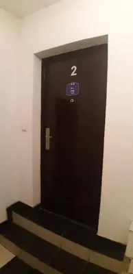 a black elevator door with a sign on it at Rosso Apartments in Belgrade