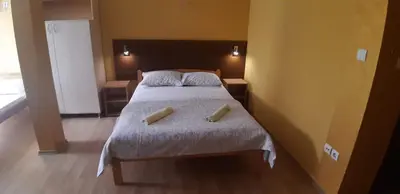a bedroom with a bed with two pillows on it at Rosso Apartments in Belgrade