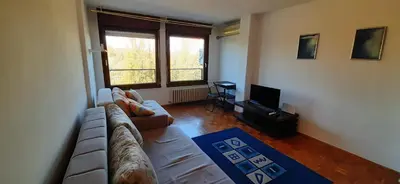 a living room with a couch and a tv at Apartment Student city, Wifi 300MBs in Belgrade