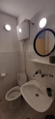 a bathroom with a sink and a toilet and a mirror at Apartment Student city, Wifi 300MBs in Belgrade
