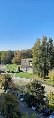 a group of parked cars parked in a park at Apartment Student city, Wifi 300MBs in Belgrade