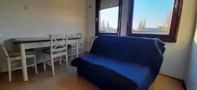 a room with a couch and a desk and a window at Apartment Student city, Wifi 300MBs in Belgrade