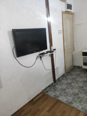 a flat screen tv hanging on a wall at Prenoćište Inđija Hrvić in Inđija