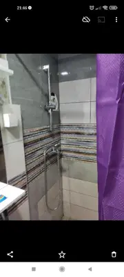 a bathroom with a shower with a purple curtain at Prenoćište Inđija Hrvić in Inđija