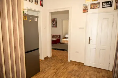 a hallway with a black refrigerator in a room at Botanical9, Belgrade centre, 2 bedroom apartment with Netflix in Belgrade