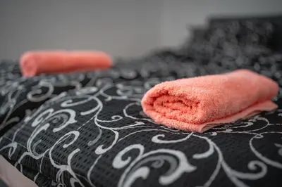 a couple of towels sitting on top of a bed at Botanical9, Belgrade centre, 2 bedroom apartment with Netflix in Belgrade